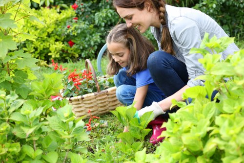 Gardeners operating tools with protective gear