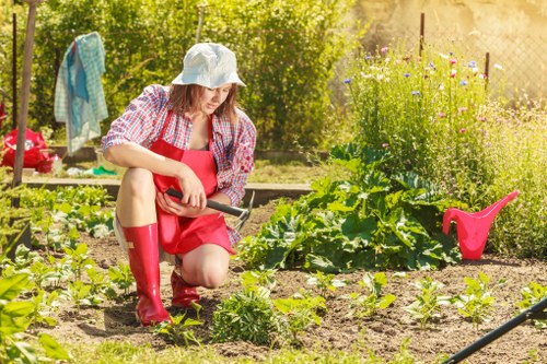 Gardener working in a small Deptford terrace garden
